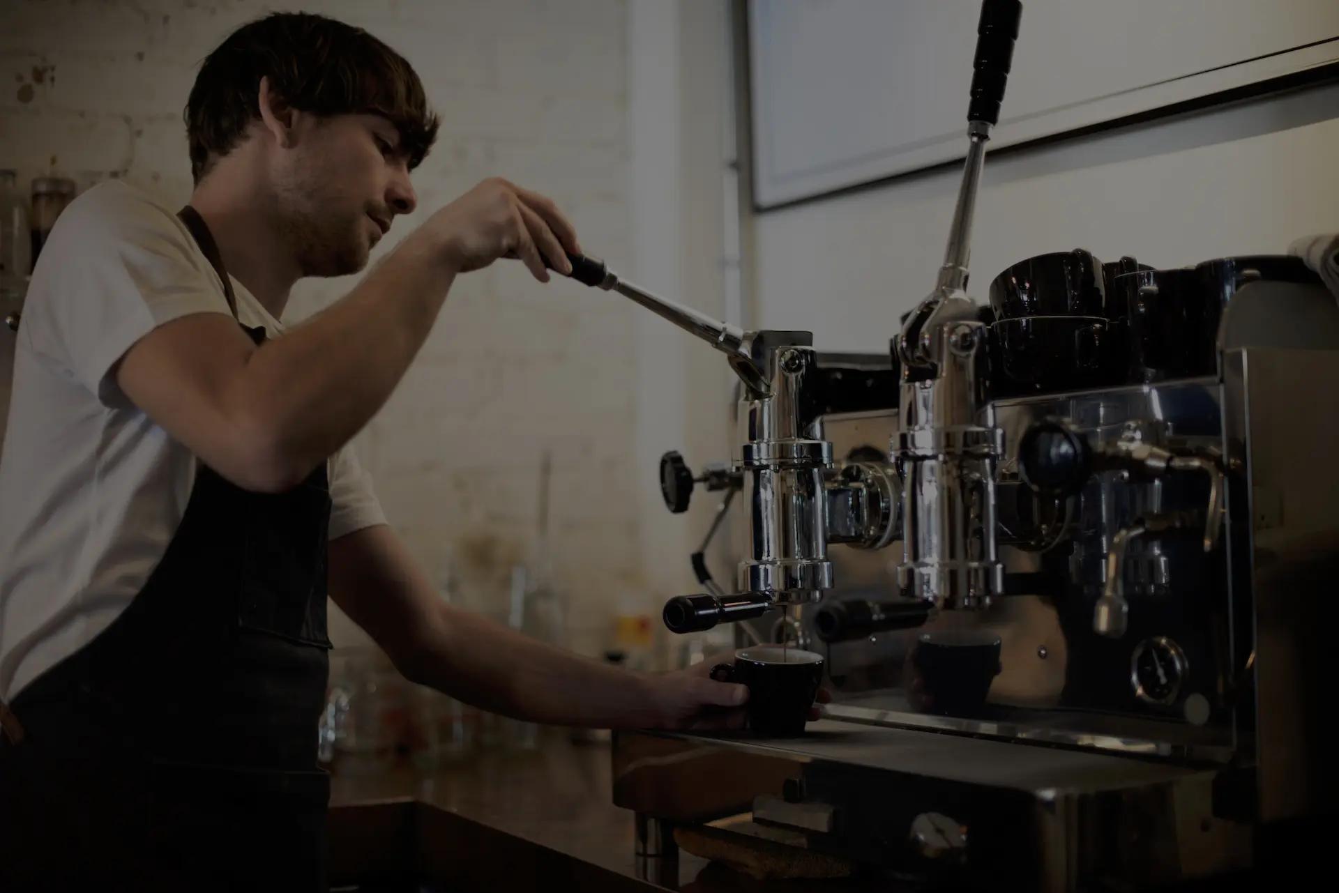 Barista extrahiert Espresso an Handhebelmaschine